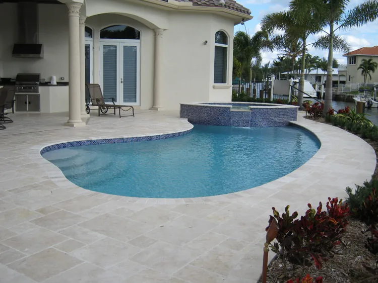 Freeform pool with travertine deck